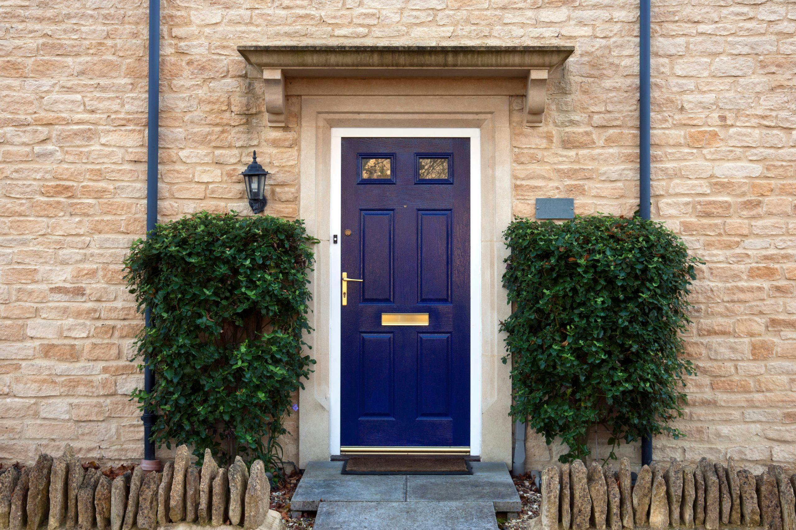 locks and key for a rental property on a blue door. The property has landlord insurance from Alan Boswell Group