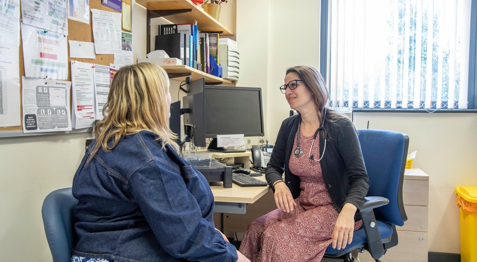 A doctor explaining to a patient what private medical Insurance covers